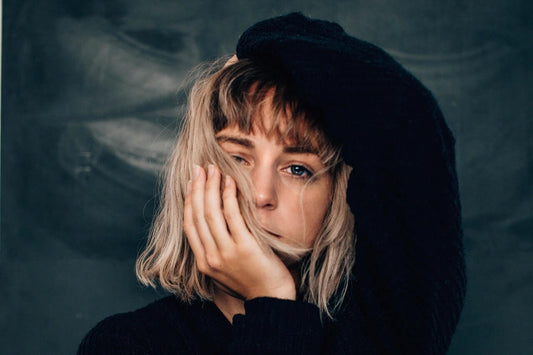 Blonde woman touching her hair