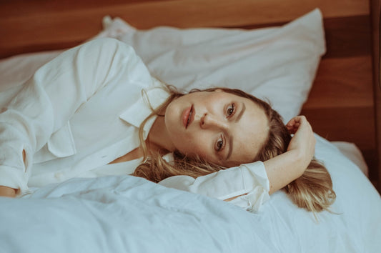 woman with blonde hair laying in bed