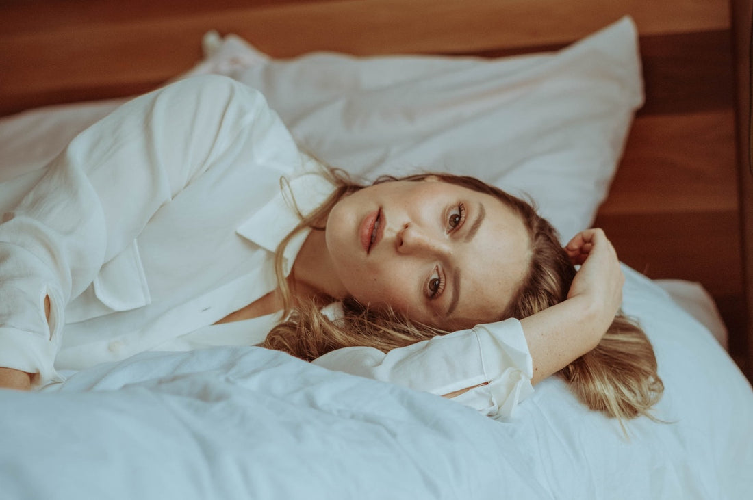 woman with blonde hair laying in bed